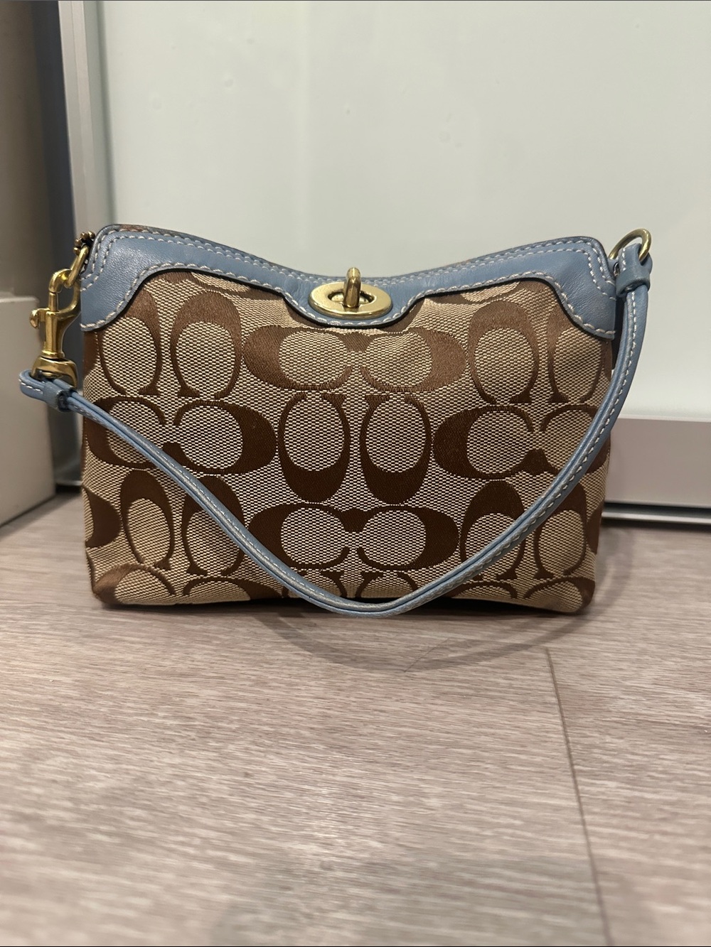 Coach Tan Signature Canvas Wristlet with Light Blue Leather Trim. Preowned.